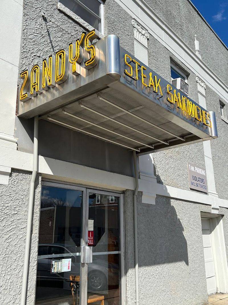 A Vintage Yellow Sign Jutting Above The Doorway