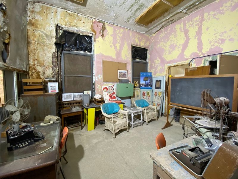 Original Floors And Institutional Corridors Remain