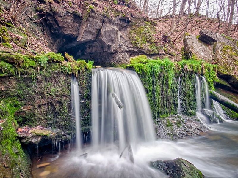 Cascading Waterfalls and Moss-Covered Rock Formations