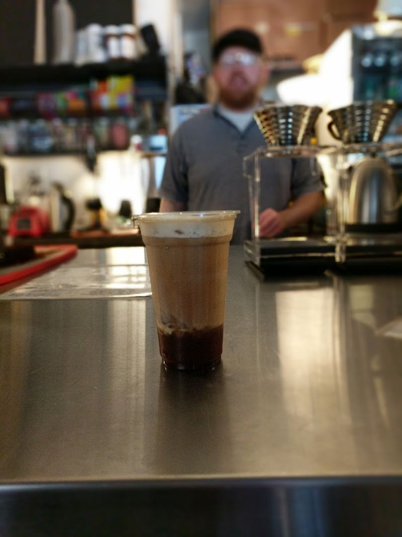A Full Cafe Brewing Coffee Behind The Counter
