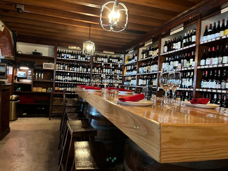 Wood Tables And Walls Stacked With Wine Bottles