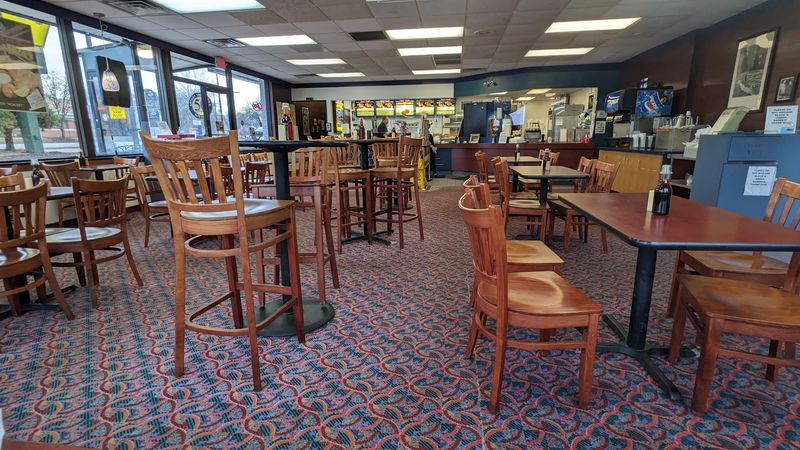 Heavy Wood Tables And Dark Paneling Throughout