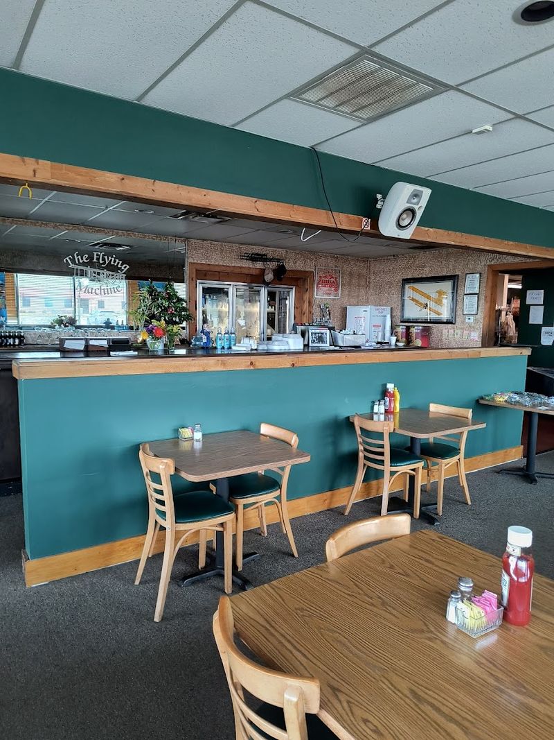 Dark Green Walls And Aviation Posters Covering Every Surface