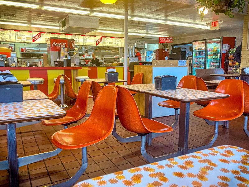 Orange Plastic Chairs And Speckled Laminate Tables