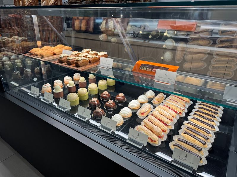 Case After Case Of Flaky Croissants And Colorful Macarons