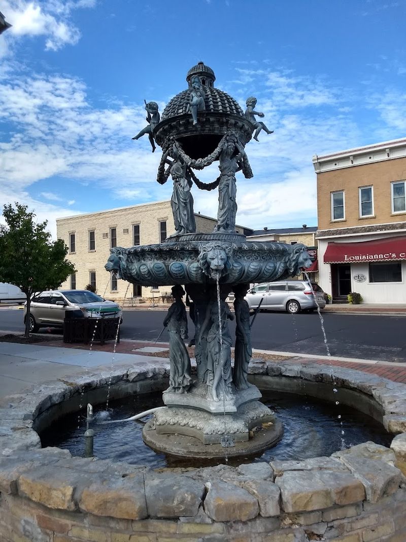 A Decorative Fountain Flowing Outside The Entrance