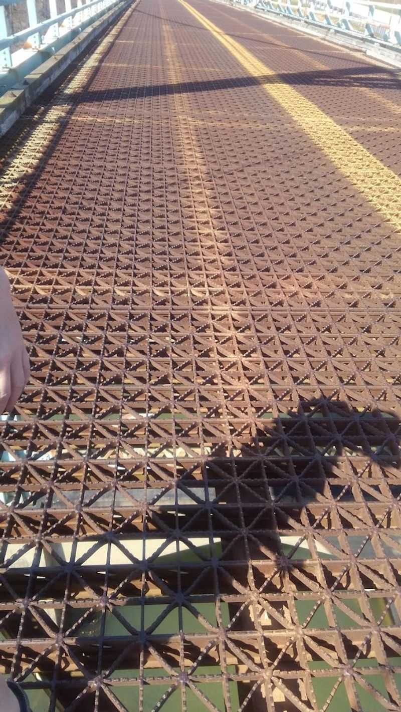 Standing on Open Grating Above Moving Water