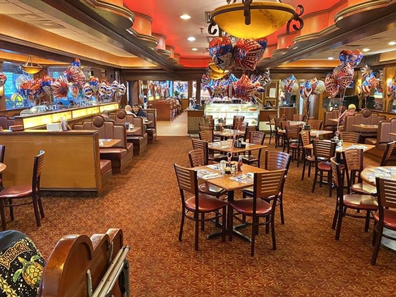 Red Booths And Polished Wood Paneling Inside