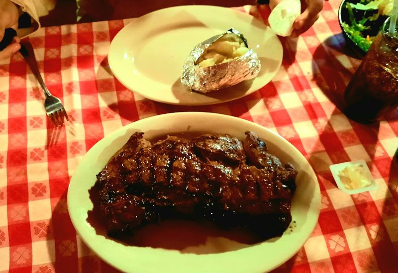 Red-Checkered Tablecloths And The Glow Of A Classic Steakhouse
