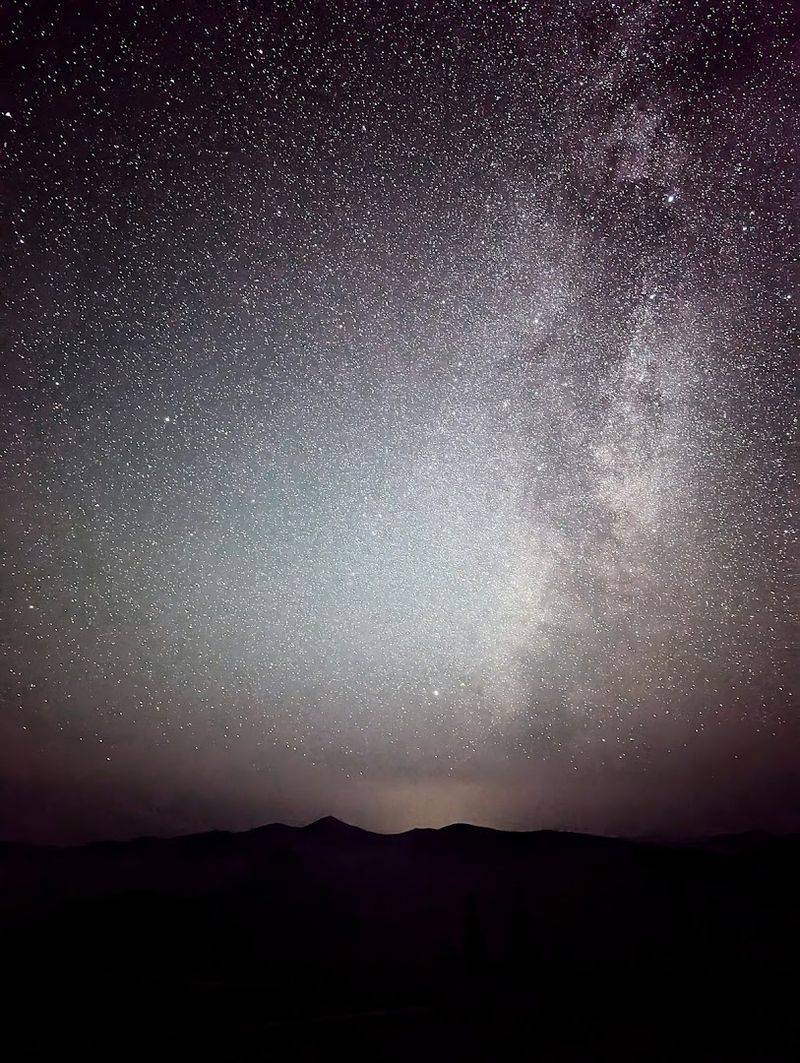 The Northern Lights Dancing Across A Crystal Studded Sky