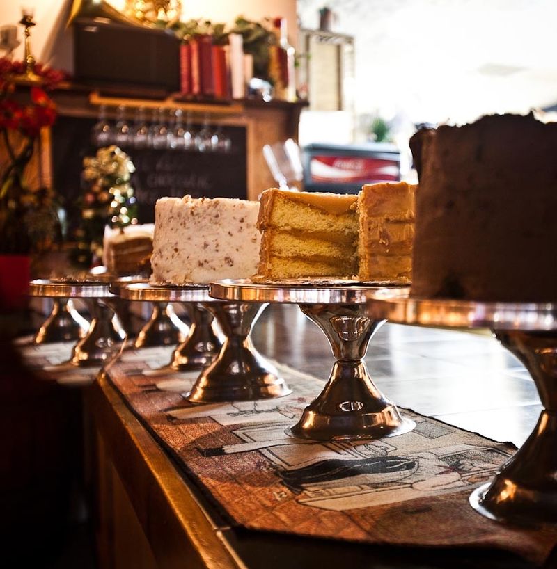 A Dessert Counter Full Of Triple Layer Cakes
