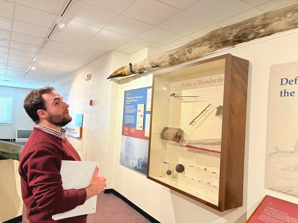 Guide at Brandywine shows off a rare underwater spear used to sink British ships during the Revolution.