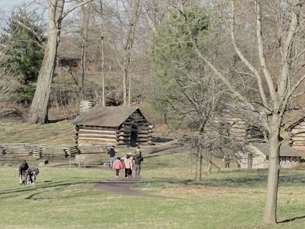 Visitors inspect the unheated, spartan troop housing at Valley Forge.