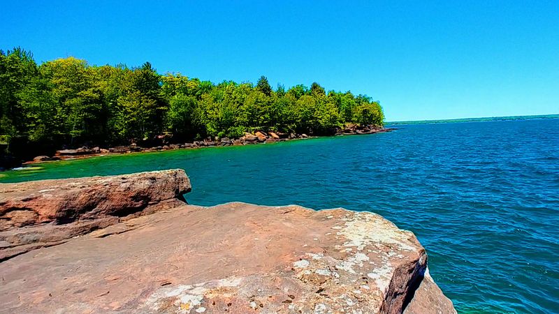 Red Sandstone Cliffs Along the Shoreline Red Sandstone Cliffs Along the Shoreline