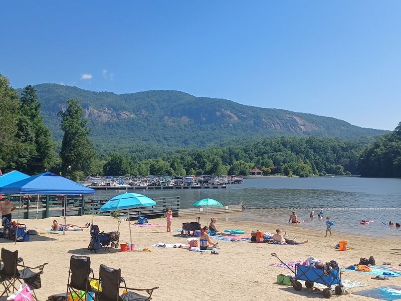 A Sandy Beach Surrounded by Mountain Views A Sandy Beach Surrounded by Mountain Views