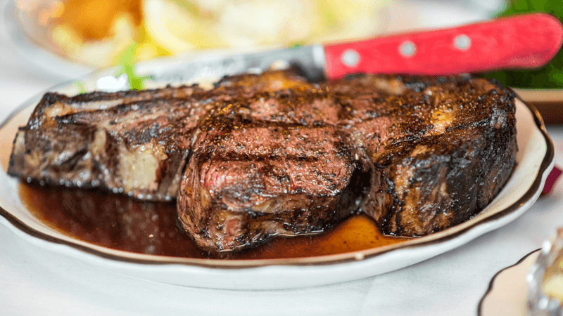 Hand Cut Ribeyes Cooked Over an Open Charcoal Hearth Hand Cut Ribeyes Cooked Over an Open Charcoal Hearth