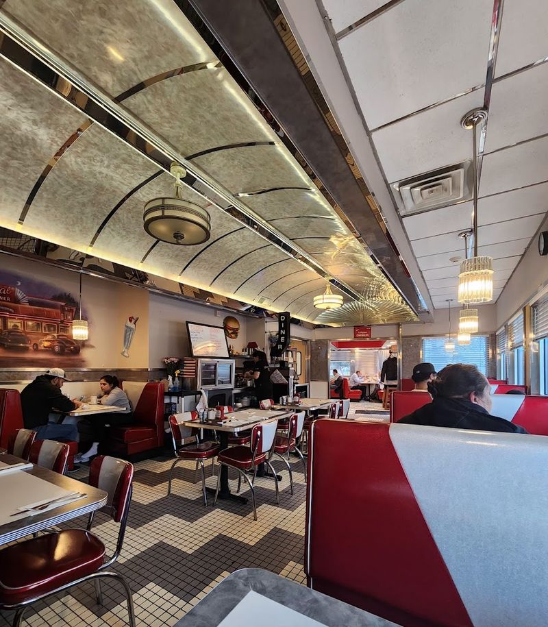 Red Vinyl Booths, Swivel Stools, and Checkerboard Floors Inside