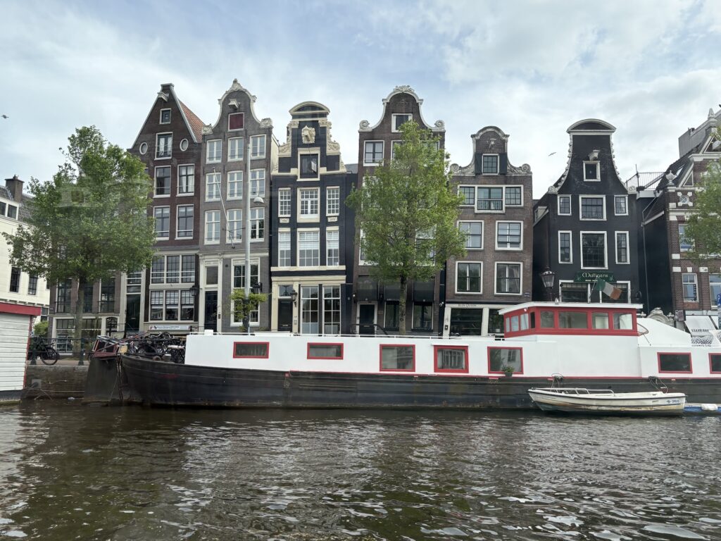 The canalside "Dancing Houses" of Amsterdam lean and sink from water seepage.