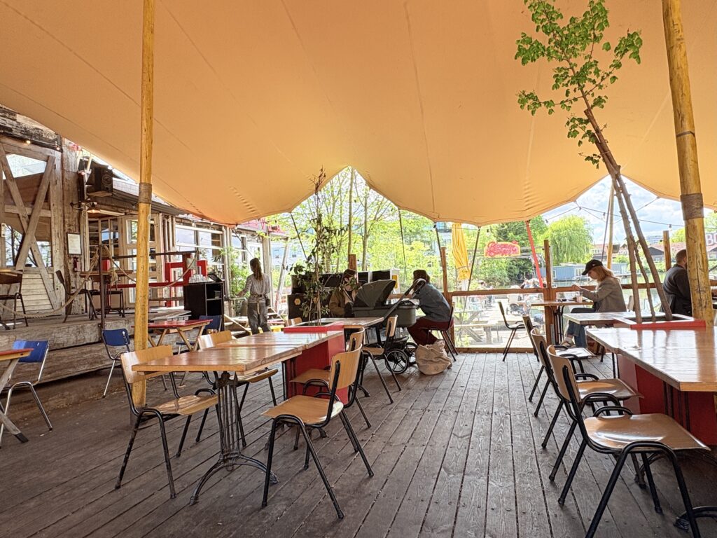 Cafe De Ceuvel serves organic vegan meals on a pier, indoors, or on the shaded outdoor deck.