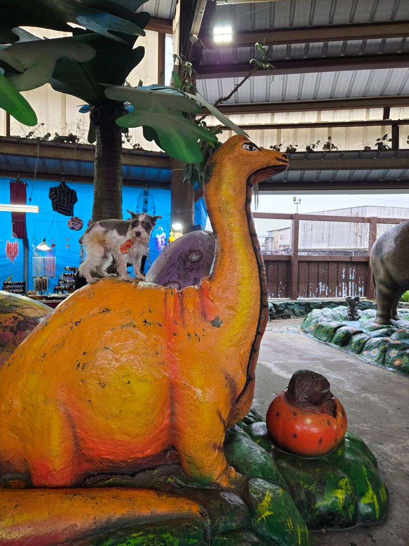 Dinosaur Statues Standing Guard Over The Aisles