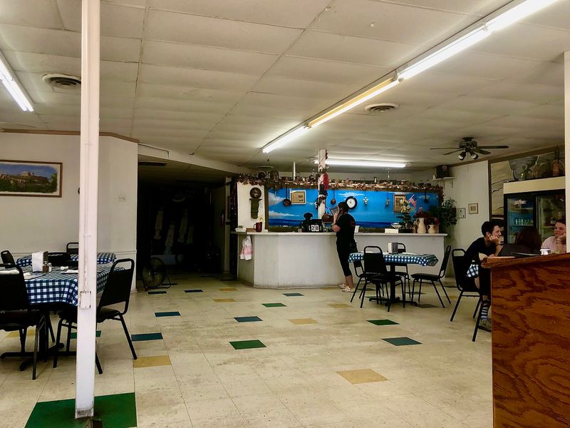 Murals, Small Tables, and a Room That Feels Lived In Murals, Small Tables, and a Room That Feels Lived In
