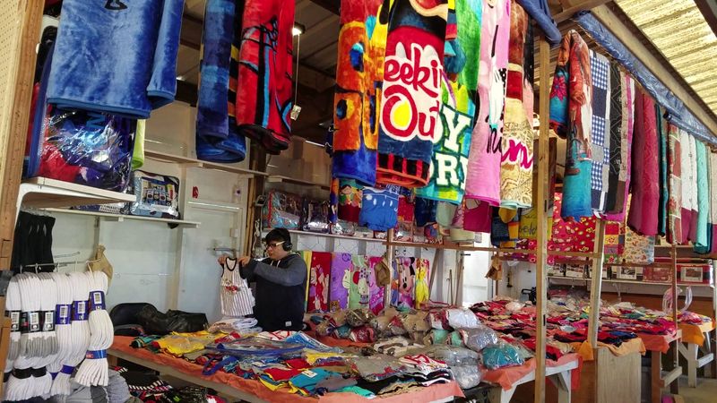 Racks Of Vintage Clothing, Boots, And Everyday Finds