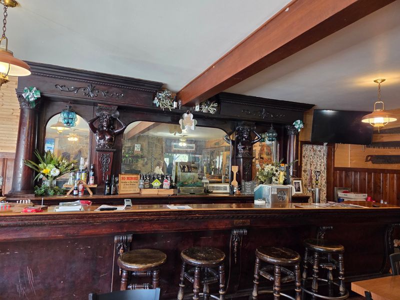 That Beautiful Antique Bar Anchoring the Room