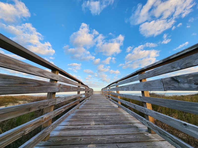 Wooden Boardwalk Winding Through the Dunes Wooden Boardwalk Winding Through the Dunes