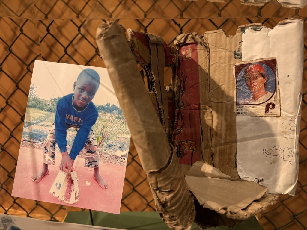 The museum features an African Little Leaguer who made his own glove from cardboard.