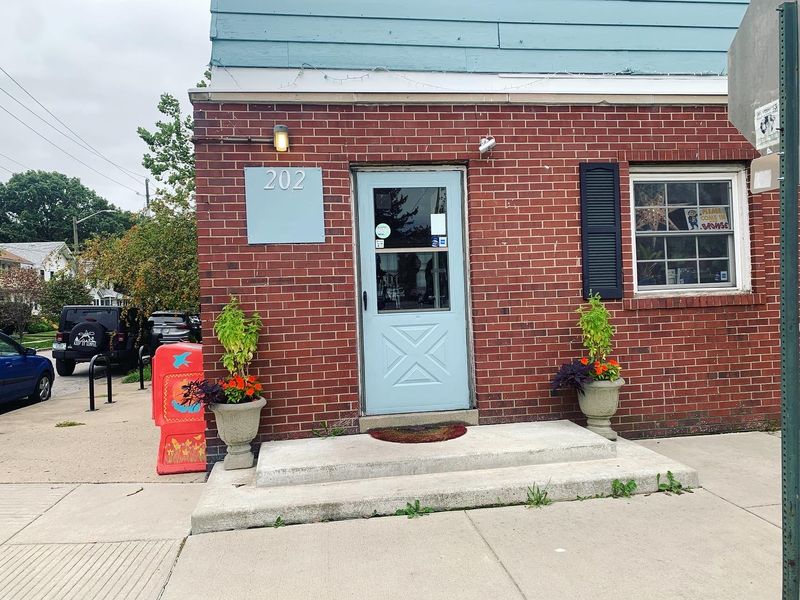 A Woman-Owned Community Hub With A Food Box Out Front A Woman-Owned Community Hub With A Food Box Out Front