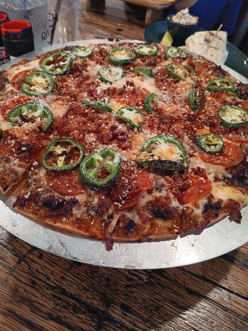Cracker-Thin Pizza With Local Toppings Piled High Cracker-Thin Pizza With Local Toppings Piled High