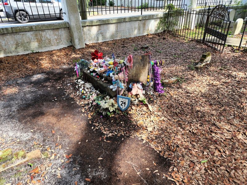 Graves Marked With Shells, Bricks, and Wooden Slabs