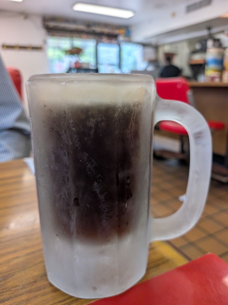 Root Beer Brewed on Site, Poured in a Frosted Mug Root Beer Brewed on Site, Poured in a Frosted Mug