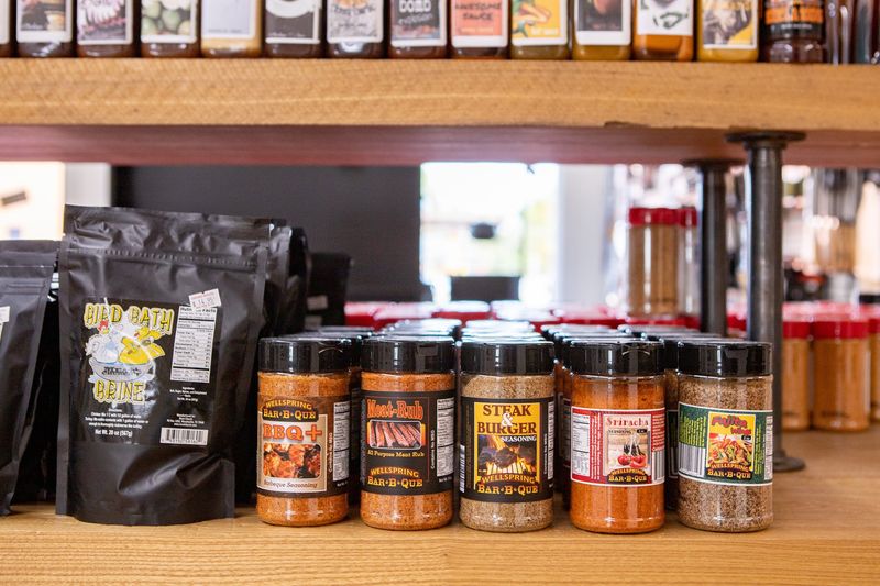 Shelves Stacked With Craft Seasonings, Sauces, And Gourmet Oils Shelves Stacked With Craft Seasonings, Sauces, And Gourmet Oils