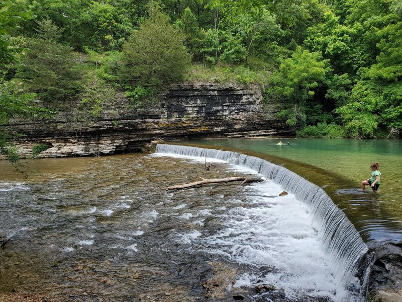The Small Waterfall And The Rock Ledges Around It