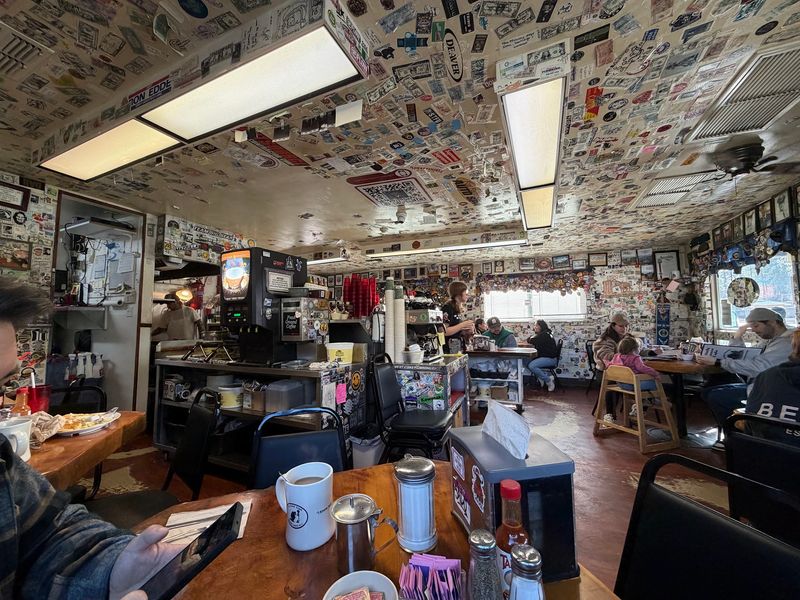 Walls Covered in Dollar Bills and Stickers
