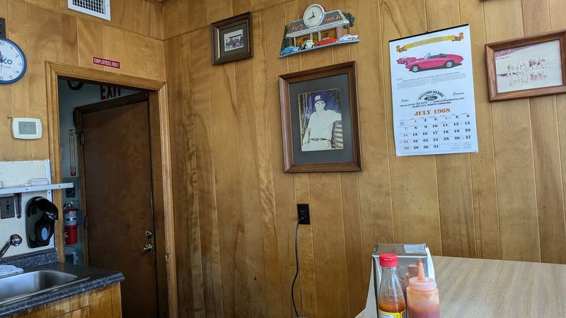 Wood Paneling, Green Vinyl, and a Room That Feels Borrowed From 1970