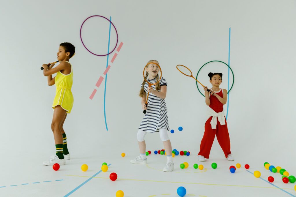 Girls at indoor tennis practice. Photo c. cottonbro for pexels.