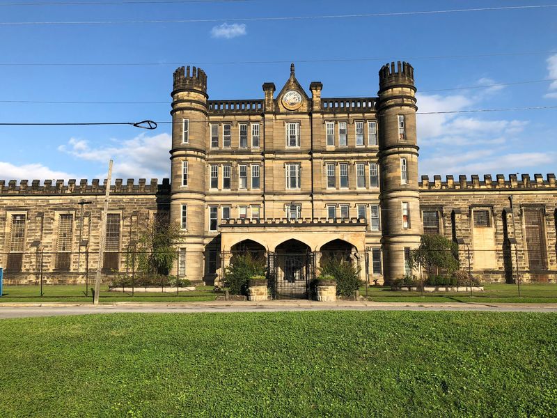 A Castle-Shaped Prison Sitting Across From An Ancient Mound