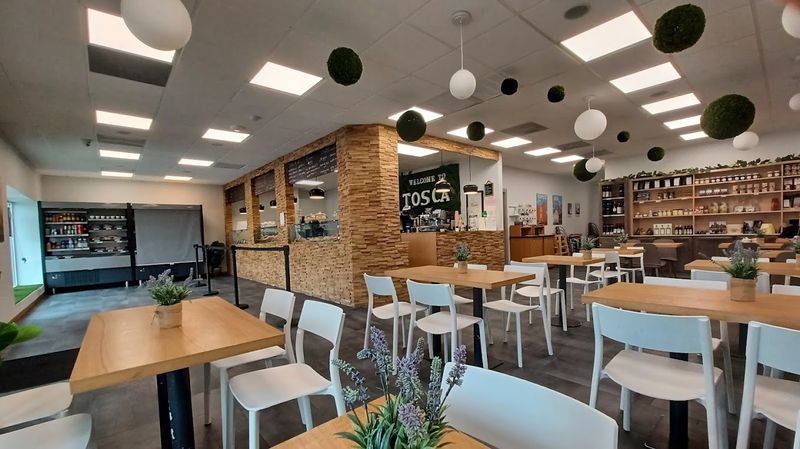 A Cozy Cafe With a Vespa Parked Right Inside A Cozy Cafe With a Vespa Parked Right Inside