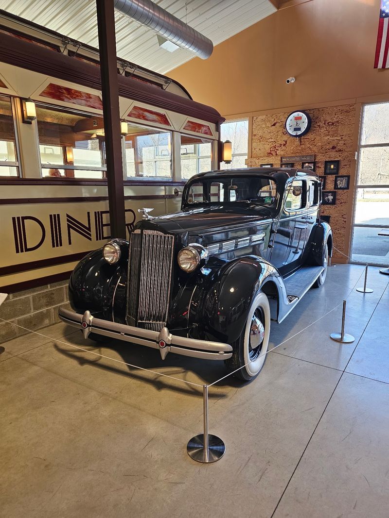 A Shiny 1937 Packard and a Cozy Tourist Cabin A Shiny 1937 Packard and a Cozy Tourist Cabin