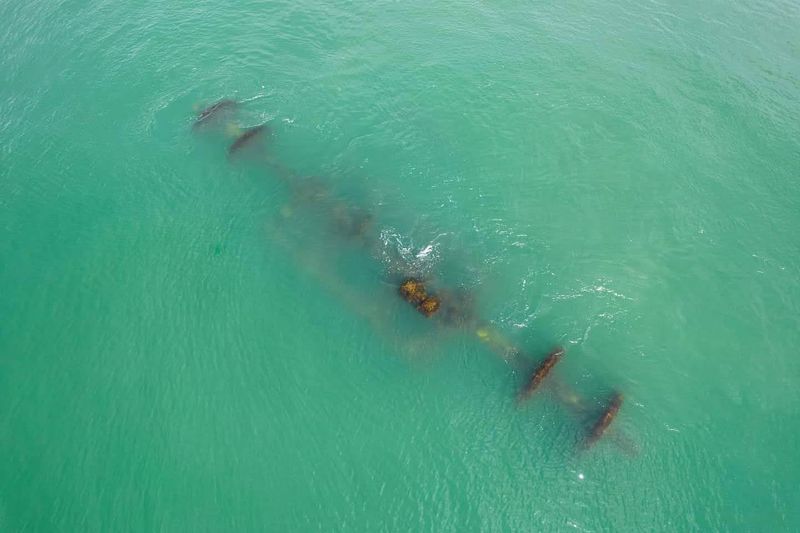 A Shipwreck Waiting Offshore