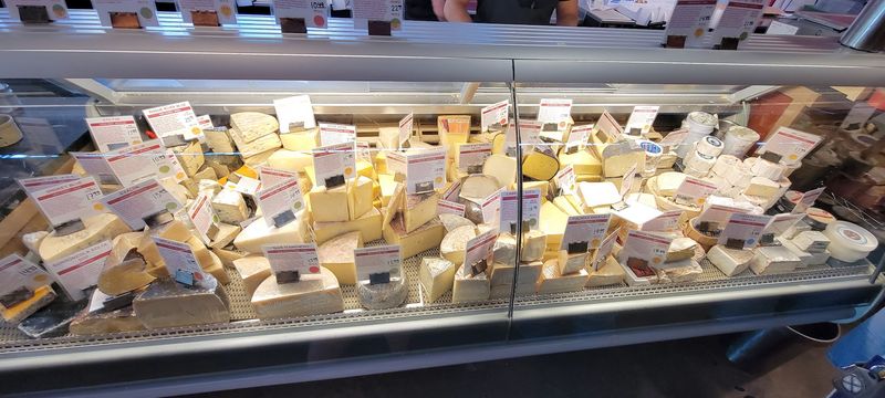 Around 100 Cheeses Waiting in One Glowing Case Around 100 Cheeses Waiting in One Glowing Case