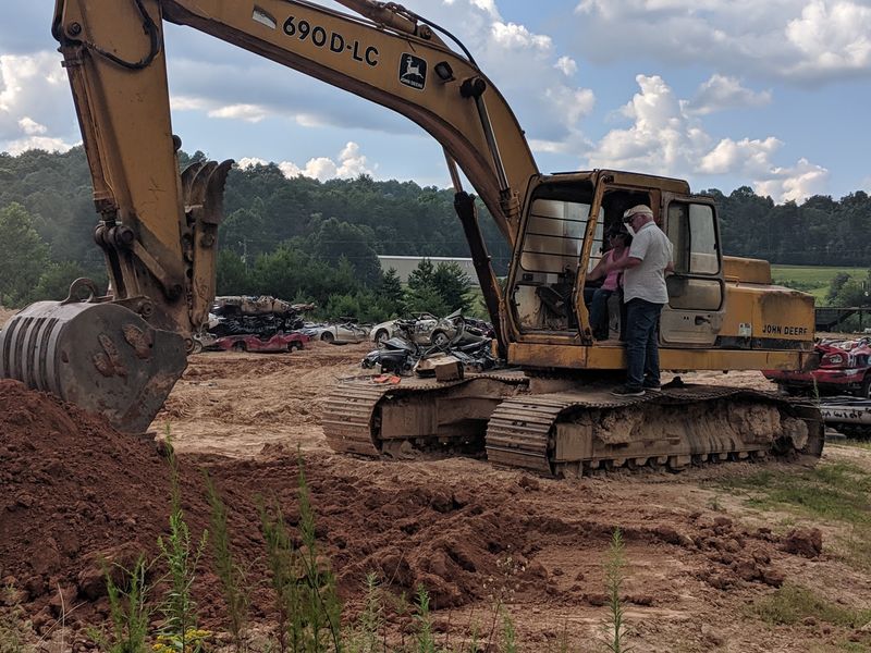 Excavators, Bulldozers, and a Vintage Machine Gun Excavators, Bulldozers, and a Vintage Machine Gun