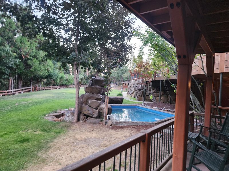 Fire Pit, Fountain, and Rocking Chairs Outside