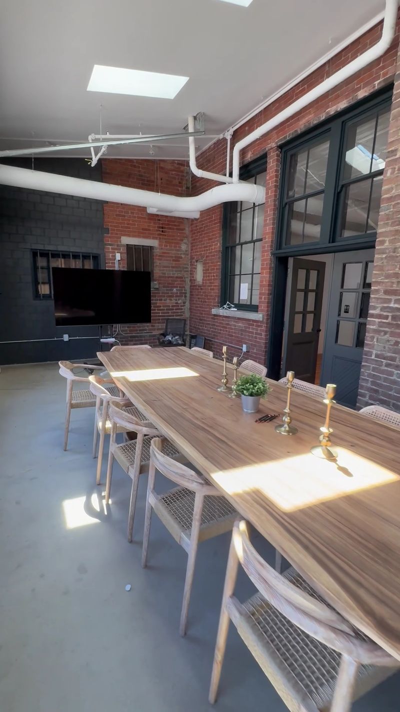 Grab A Seat At The Long Wooden Table In The Back Room