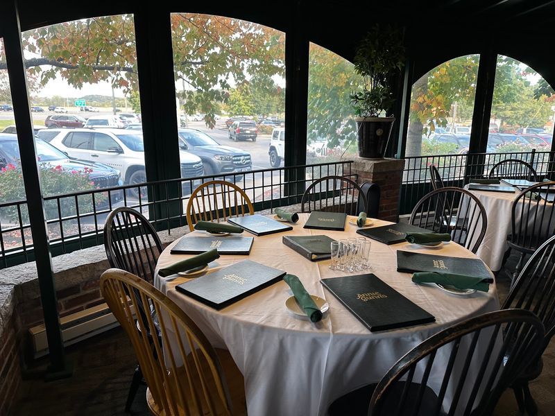 Green Walls, White Tablecloths, And A Crackling Fireplace