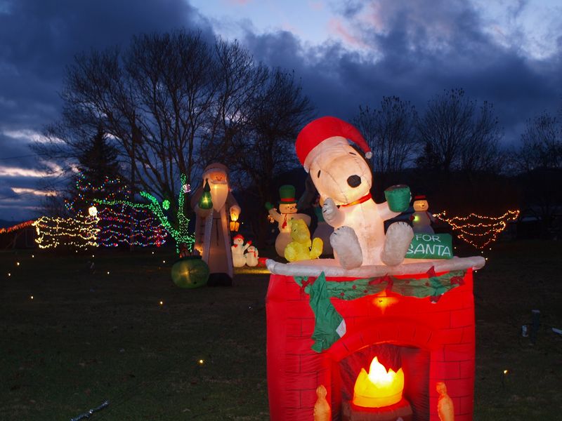 Inflatables, Twinkling Lights, and a Nativity Scene Sharing One Street