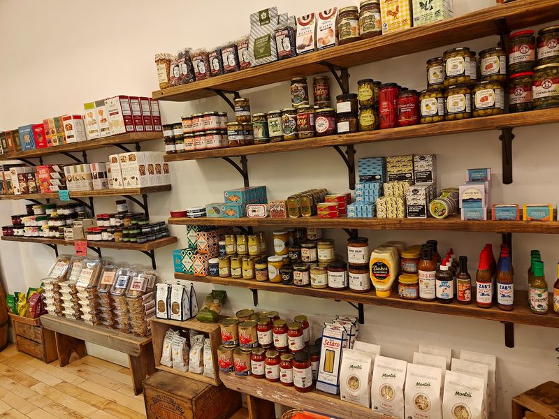 The Pantry Shelves Are Packed With Tinned Fish And Treats