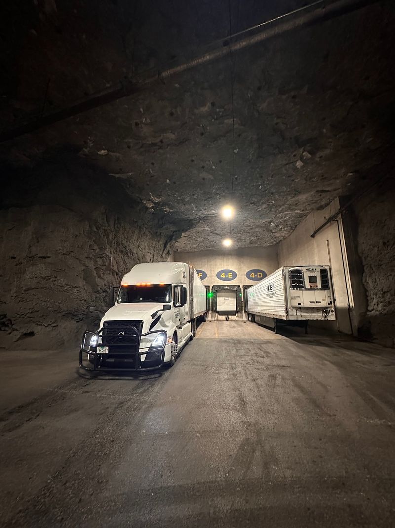 Trucks And Trains Rolling Through Stone